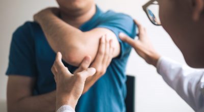 Physical therapists are checking patients elbows at the clinic office room. Physical therapists are checking patients elbows at the clinic office room.